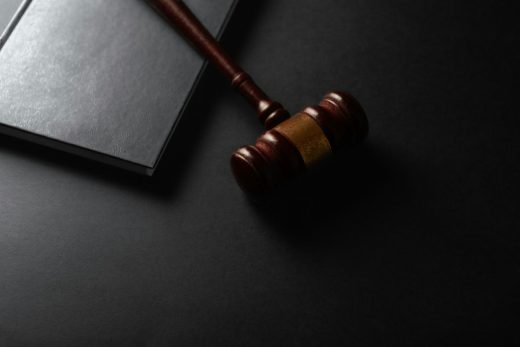 Mazo de juez de madera junto a un libro de derecho sobre una mesa oscura: sentencias ganadas con la Ley de Segunda Oportunidad